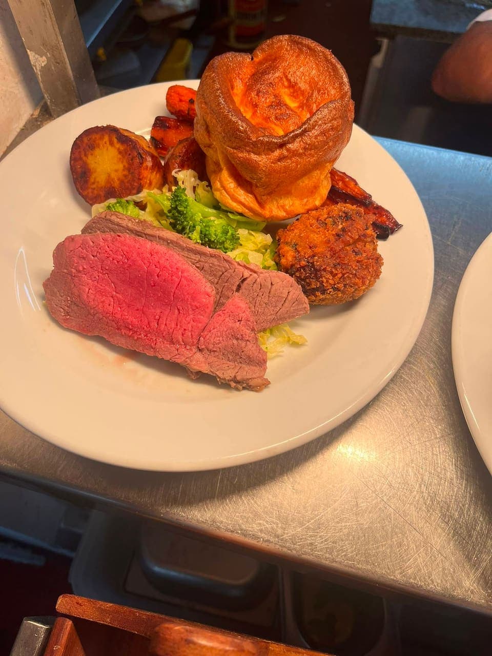 Sunday roast at The White Horse: sliced roast beef with a Yorkshire pudding, roast potatoes, carrots and greens
